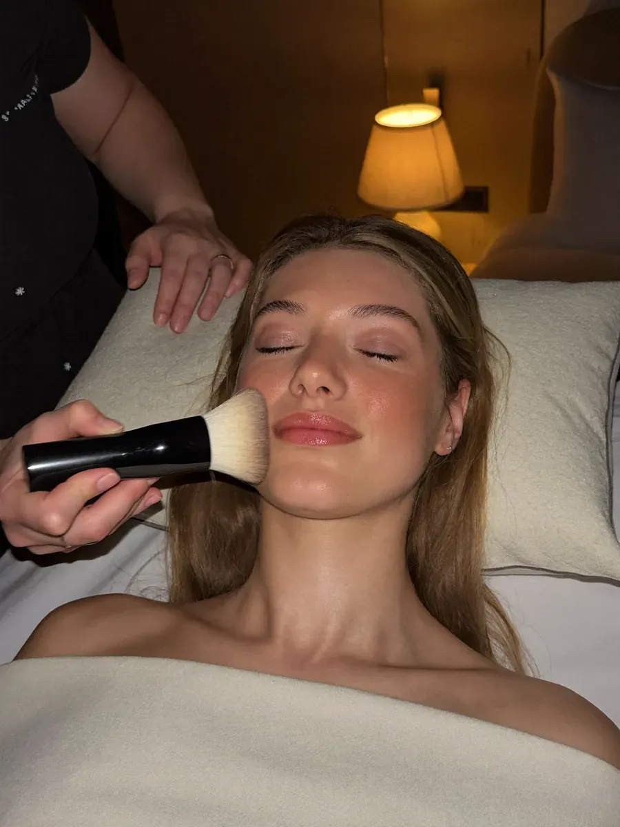 A fluffy brush swept across a client's cheek during a Sensory Bliss treatment